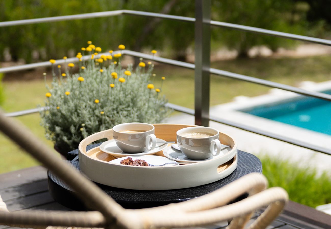 Bandeja com café e flores decorativas com vista para o jardim na Pool Beach & Golf Troia.
