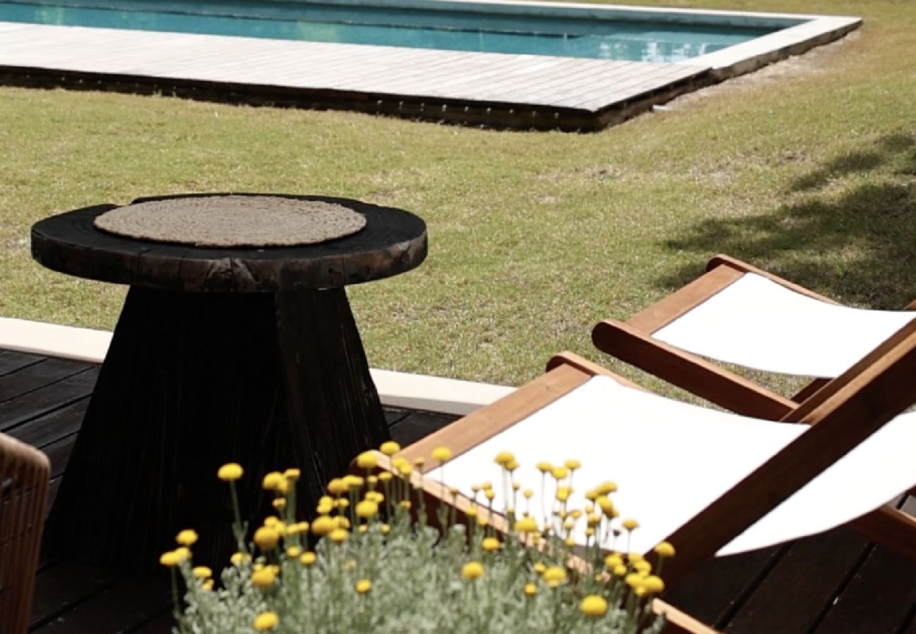 Mesa ao ar livre elegantemente decorada com vista para o jardim na Pool Beach & Golf Troia.