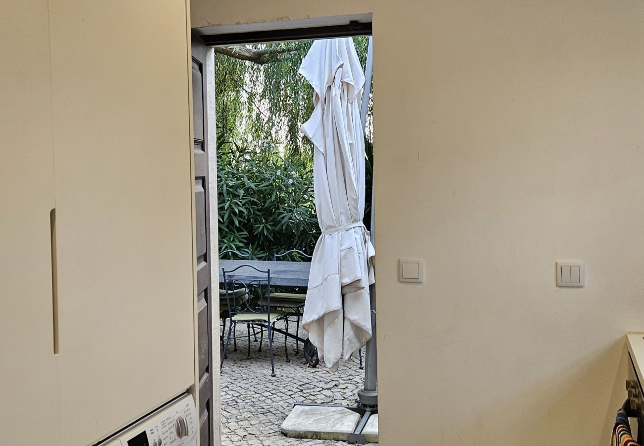 Bright laundry room with door opening onto the garden and visible towel rail.