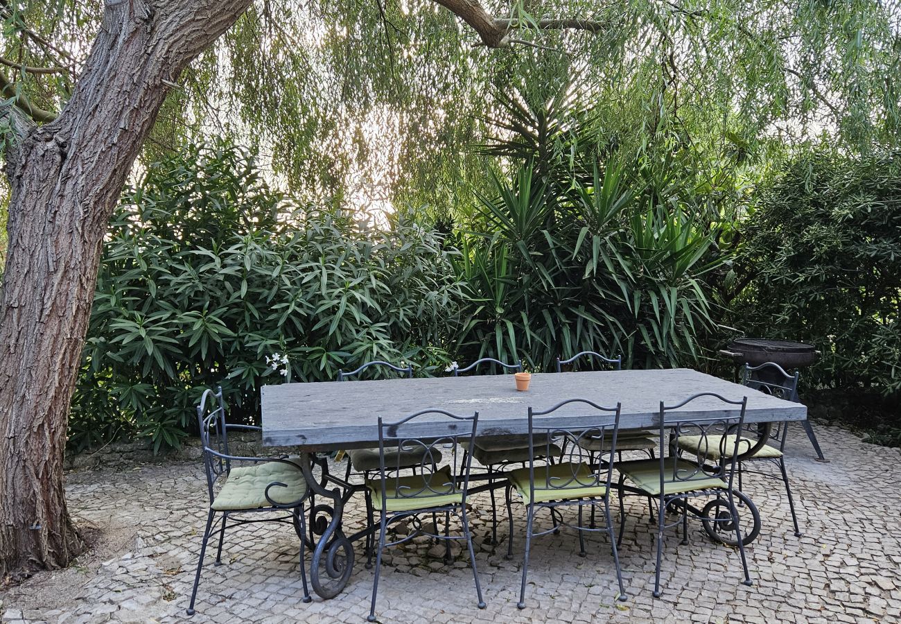 Outdoor seating area with chairs, view of the private pool and surrounding countryside and sea.