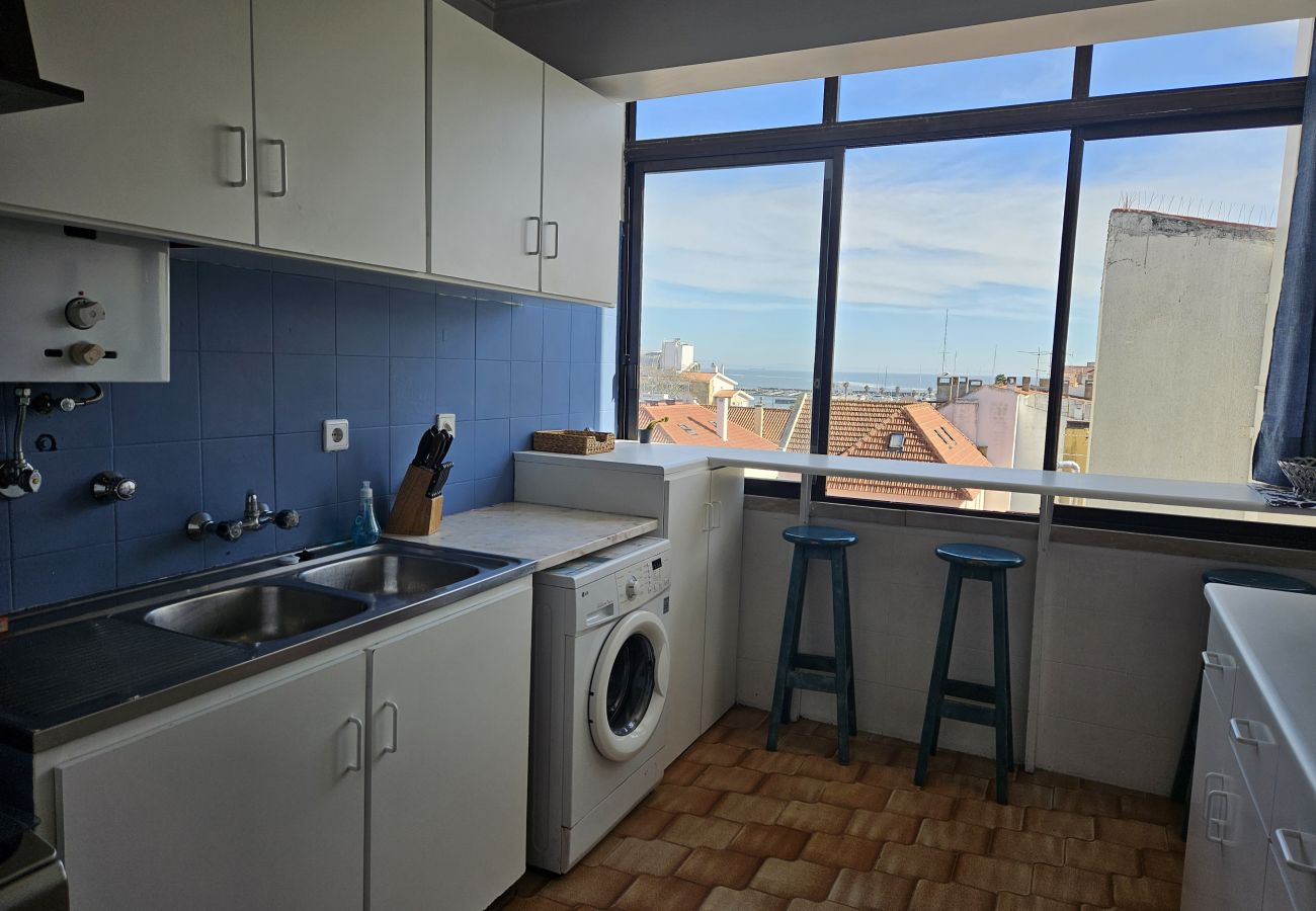 Functional kitchen with appliances and large windows for a beautiful view.