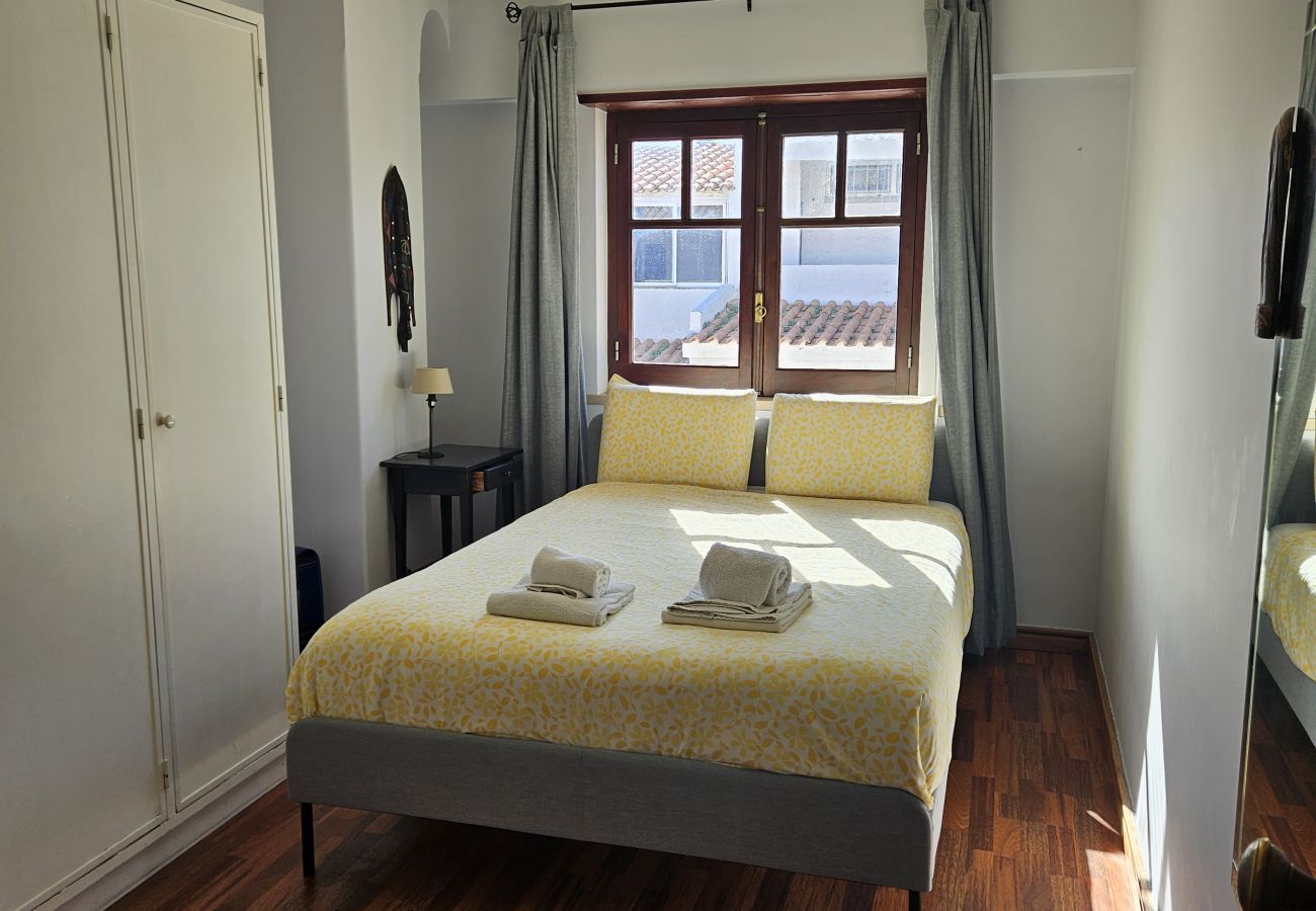 Airy room with double bed and large windows. 