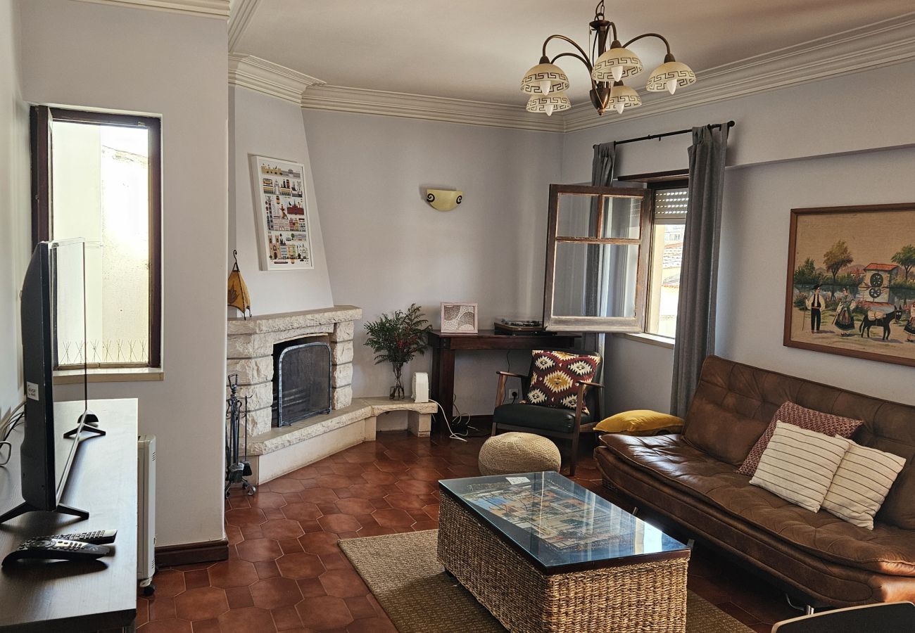 Spacious living room with cozy sofa, coffee table, and natural light. 