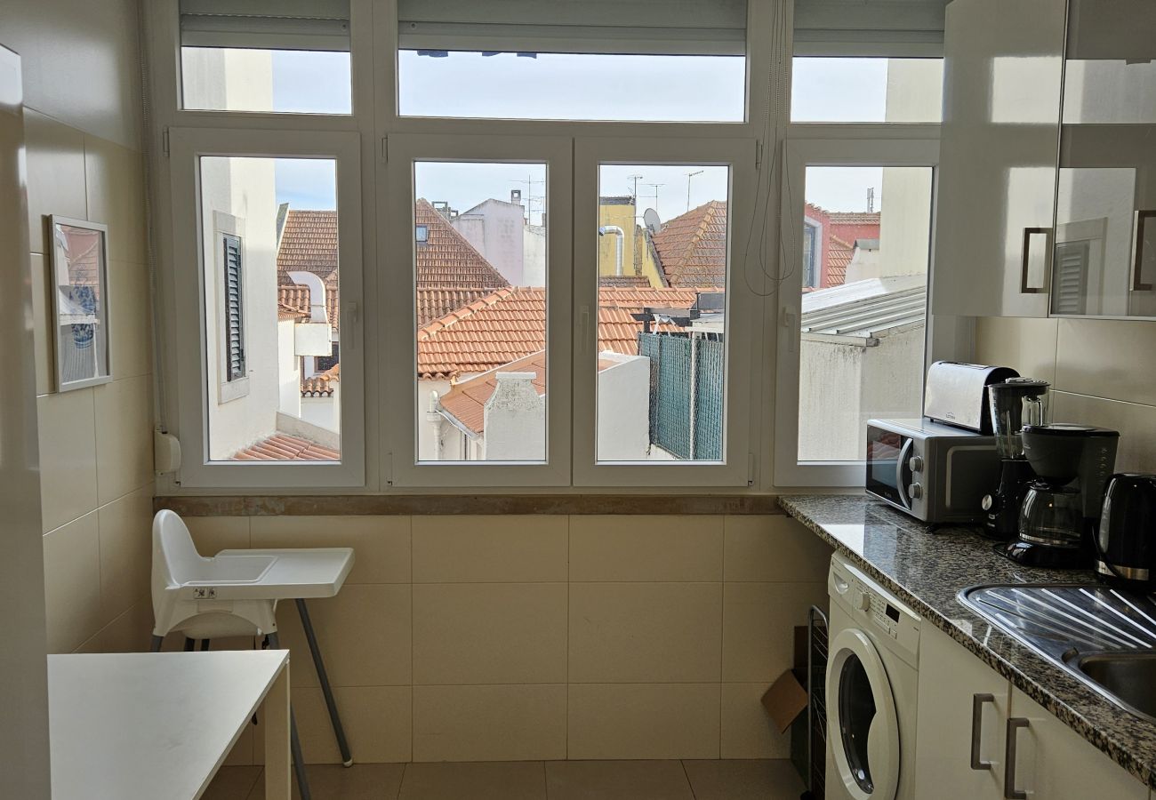 Functional kitchen with essential appliances, a spacious countertop, and natural light.