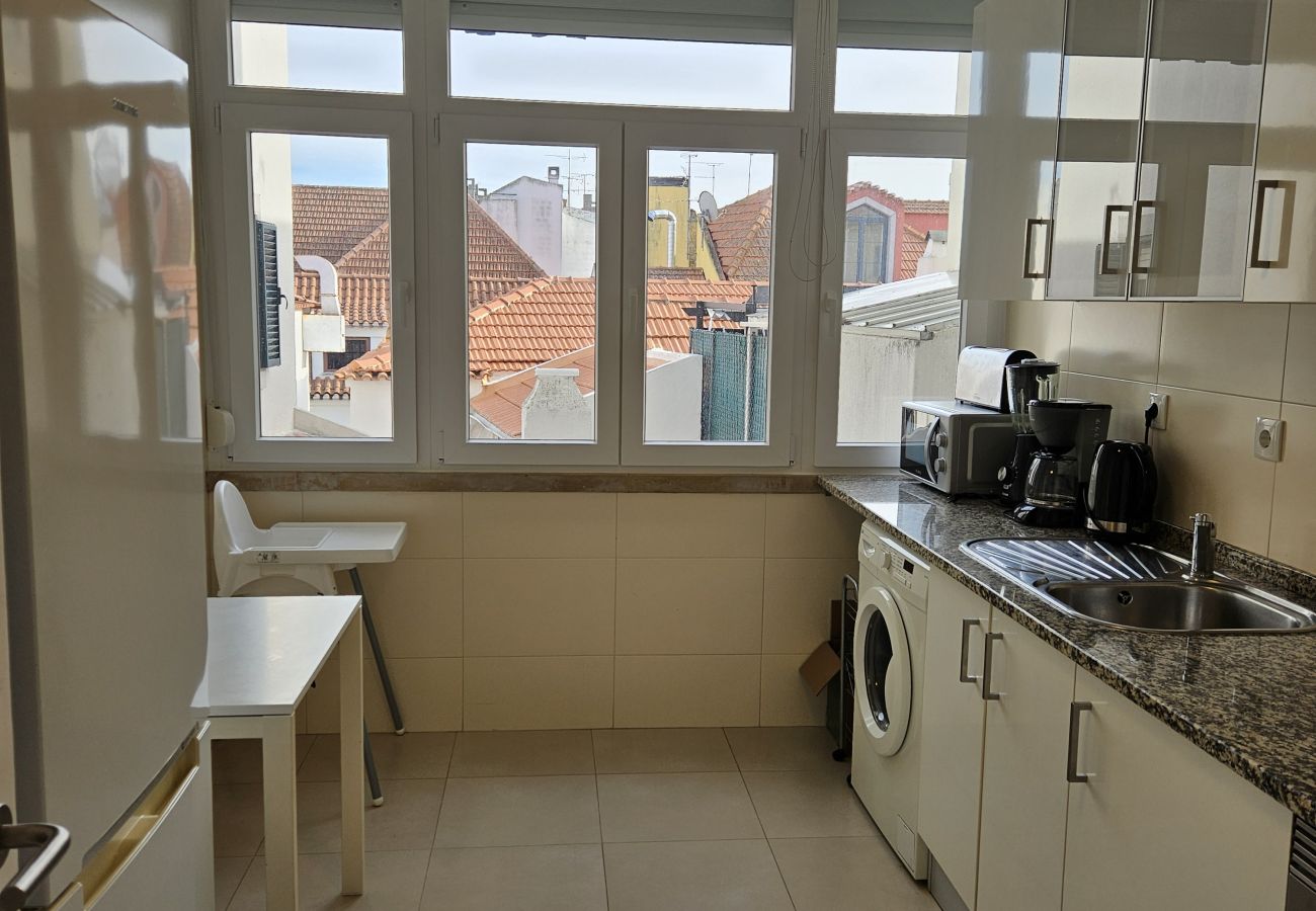 Modern kitchen with large windows and incredible city views. 