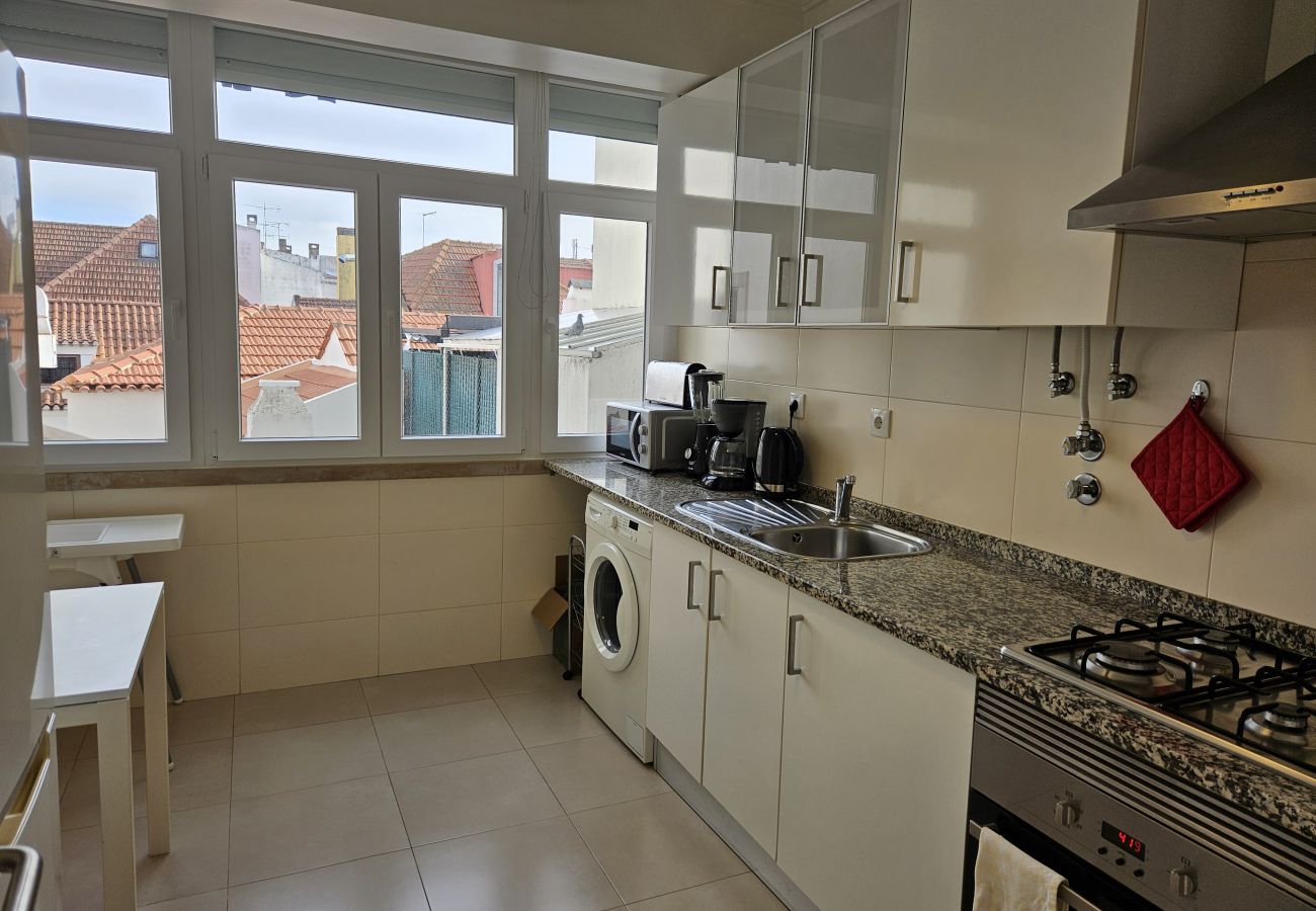 Modern kitchen with large windows and incredible city views. 