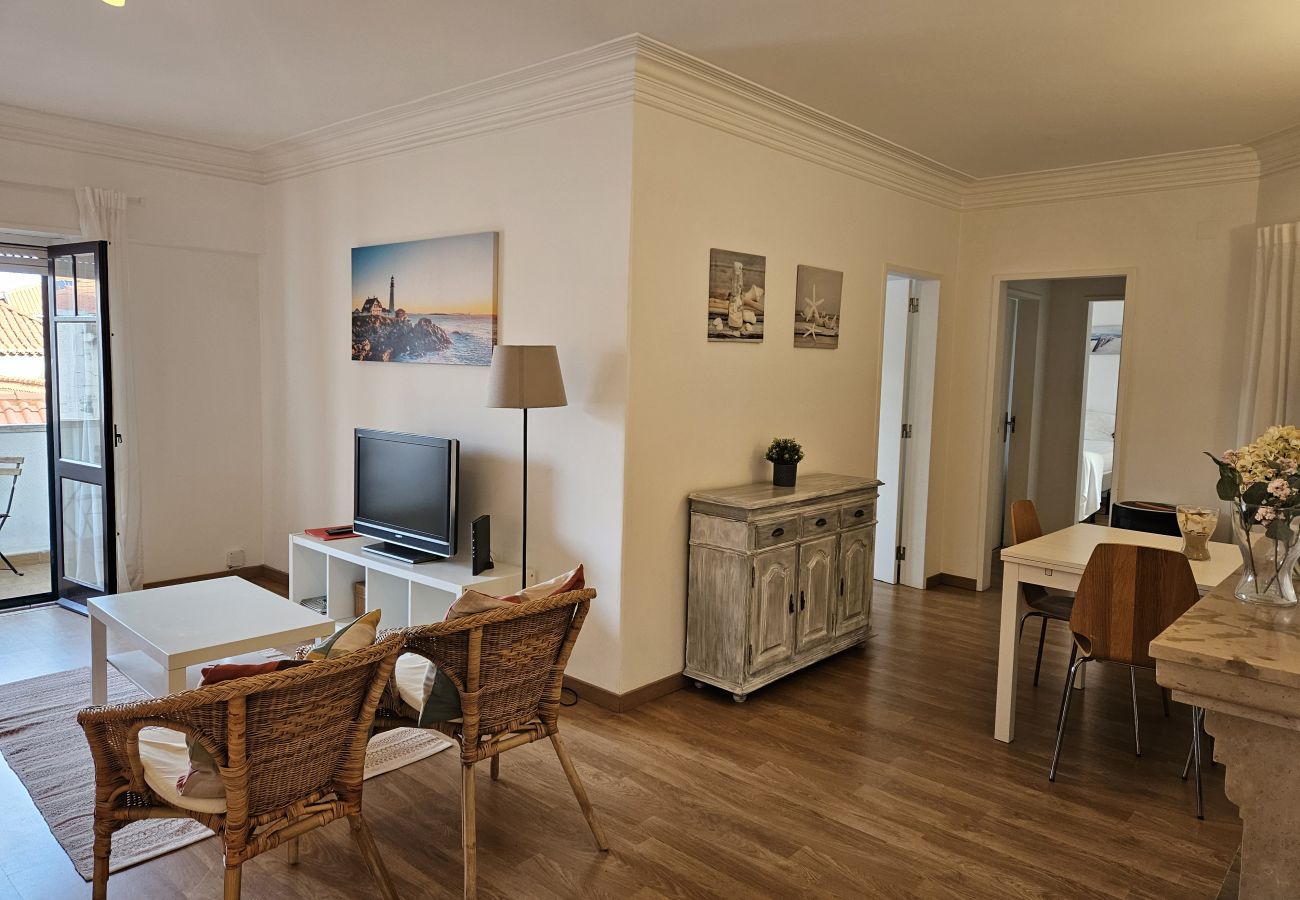 Living room with comfortable sofa, dining table and modern décor. 