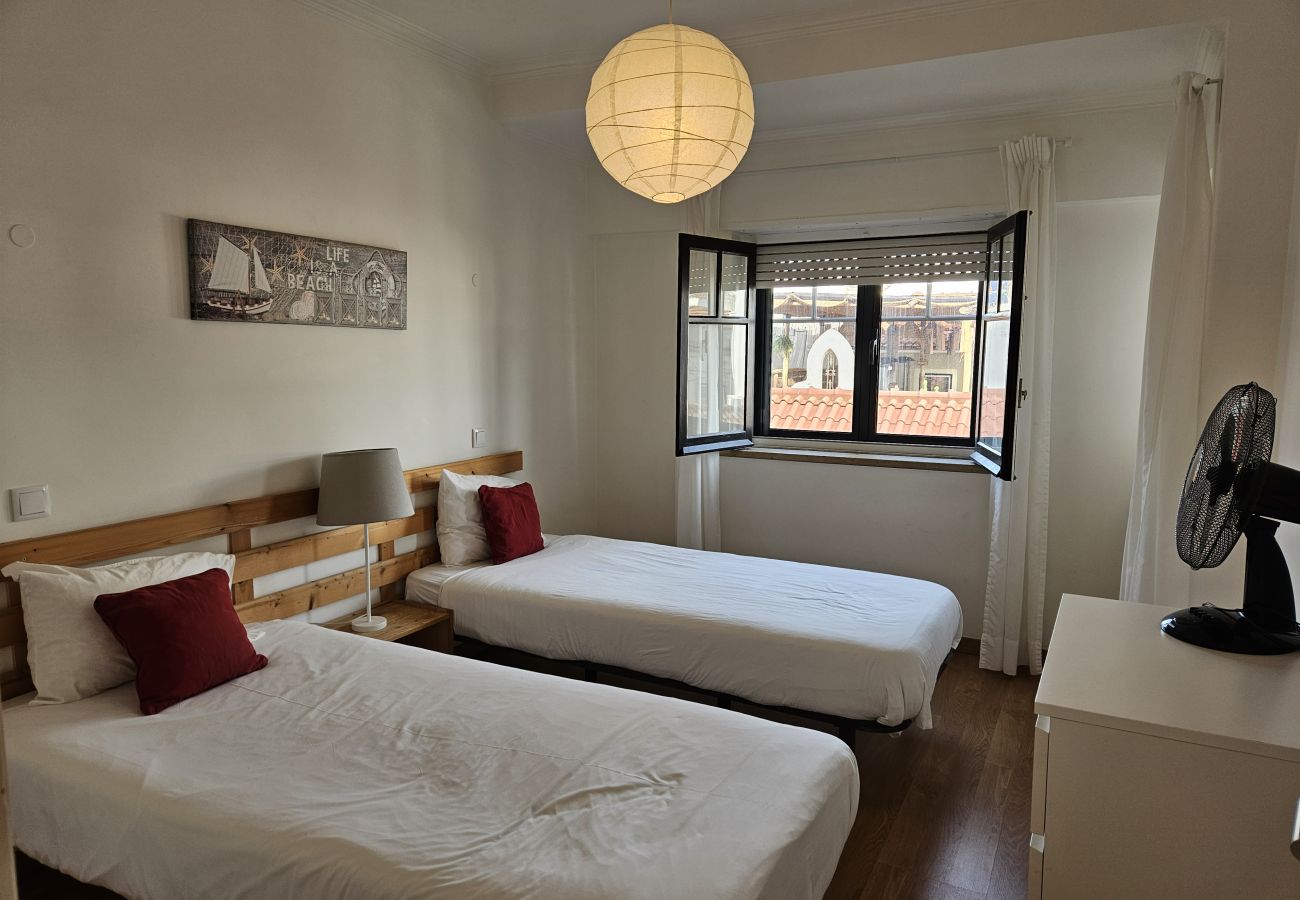 Comfortable room with two single beds and neutral colours.