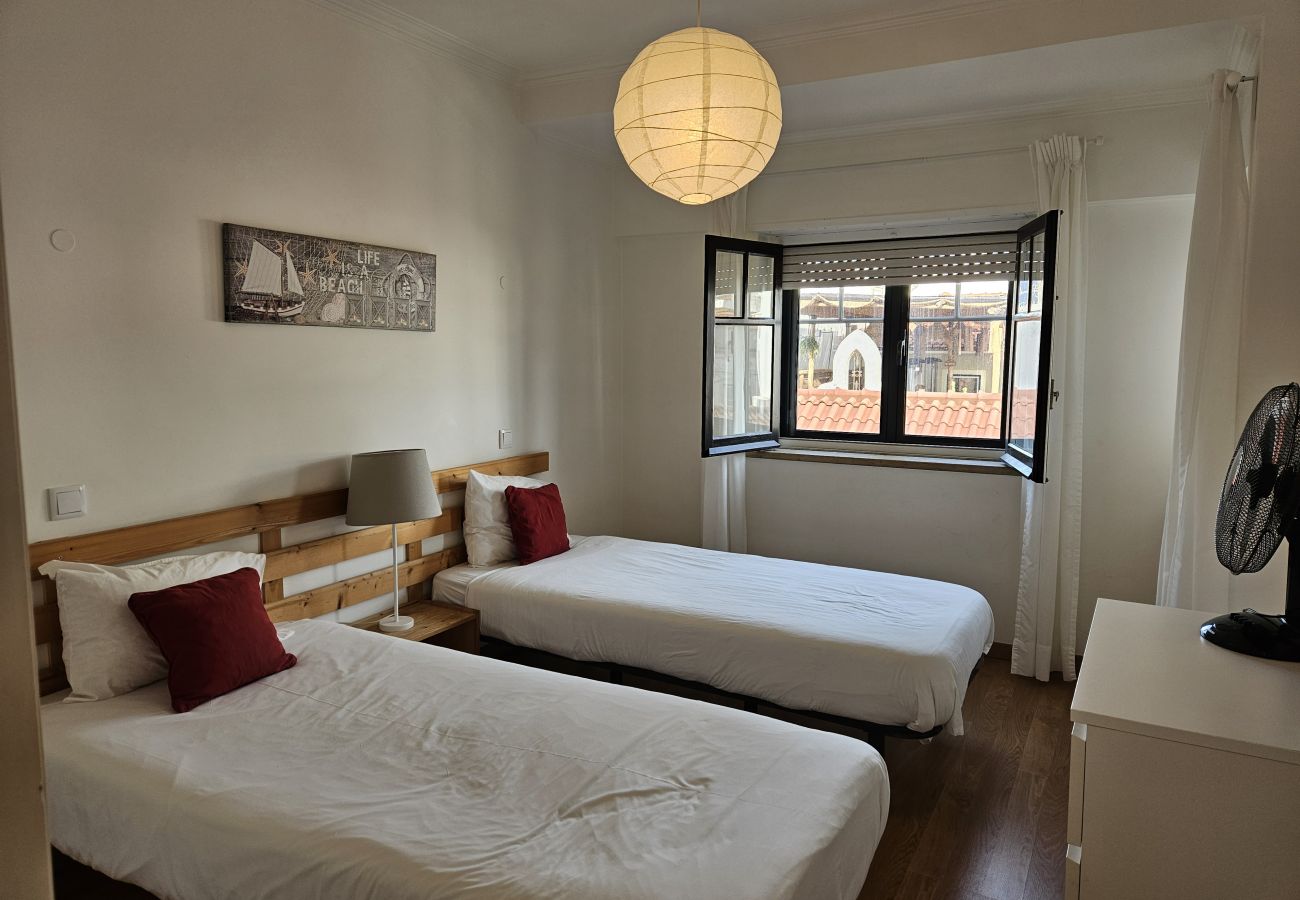 Comfortable room with two single beds and neutral colours. 