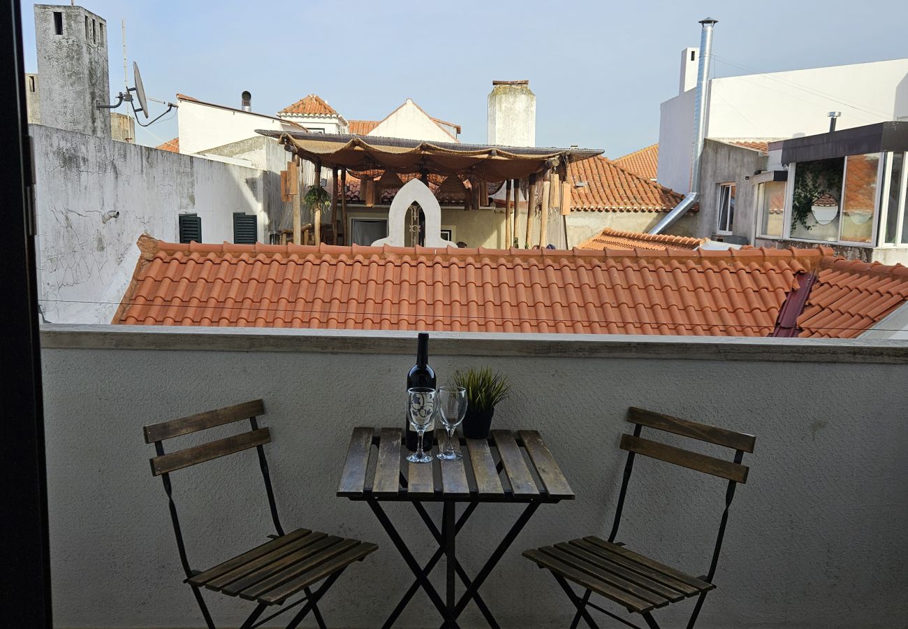 Balcony with a small table and two chairs, perfect for enjoying fresh air.