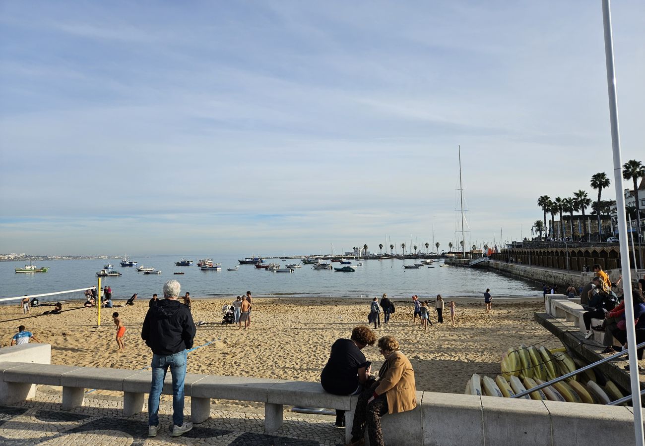 Cascais beach at sunset, with golden reflections on the sea and a peaceful atmosphere. 