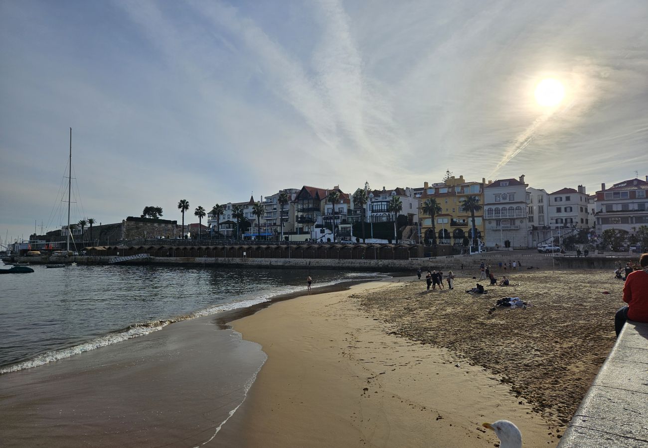 Cascais beach on a winter day with a clear blue sky, bright sun, and calm sea.. 
