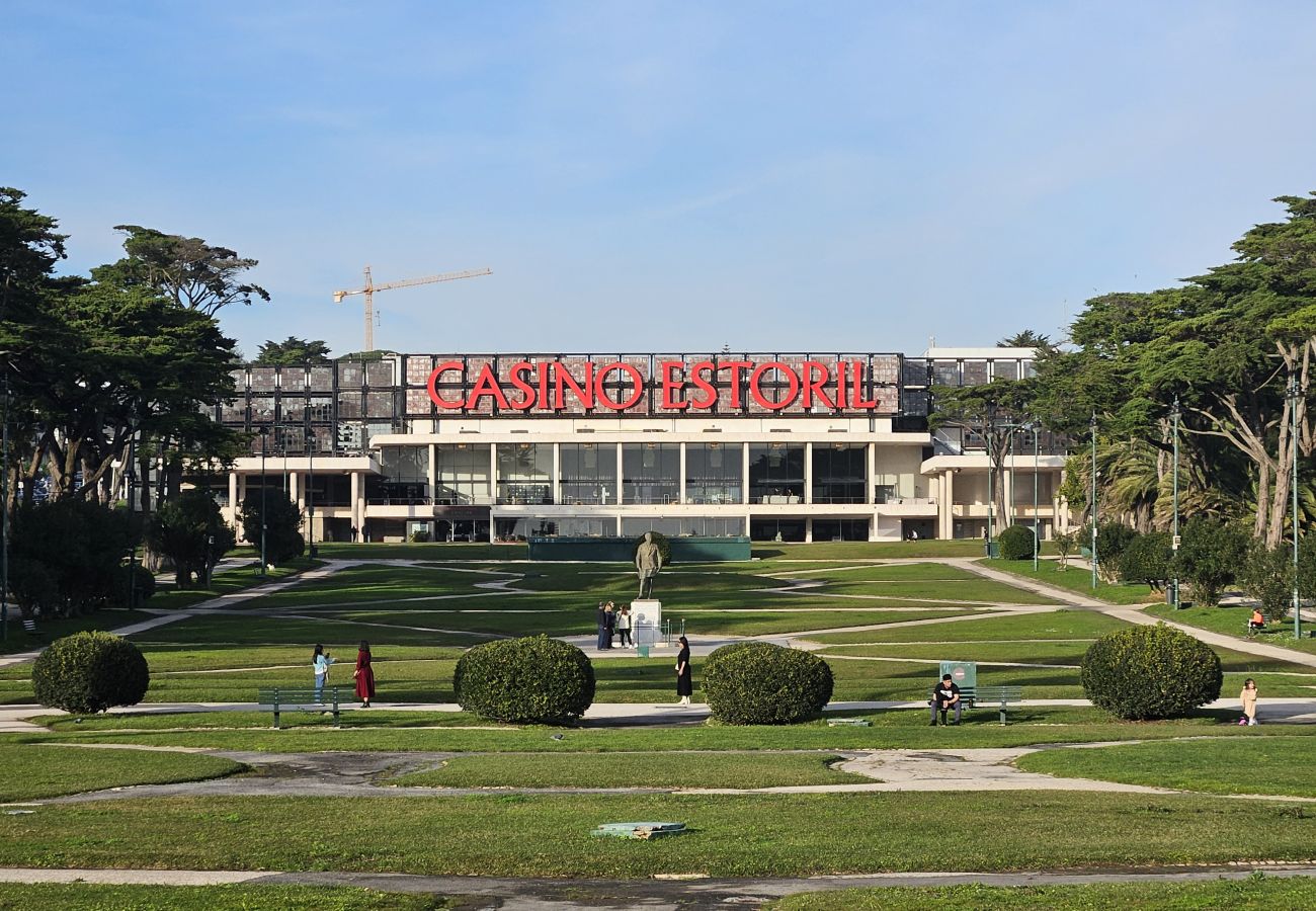 Illuminated facade of Casino Estoril, featuring grand architecture and a sophisticated ambiance. 