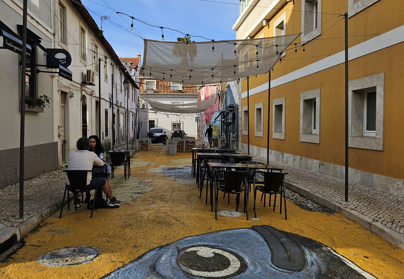 Cascais' iconic street with yellow façades and traditional shops. 