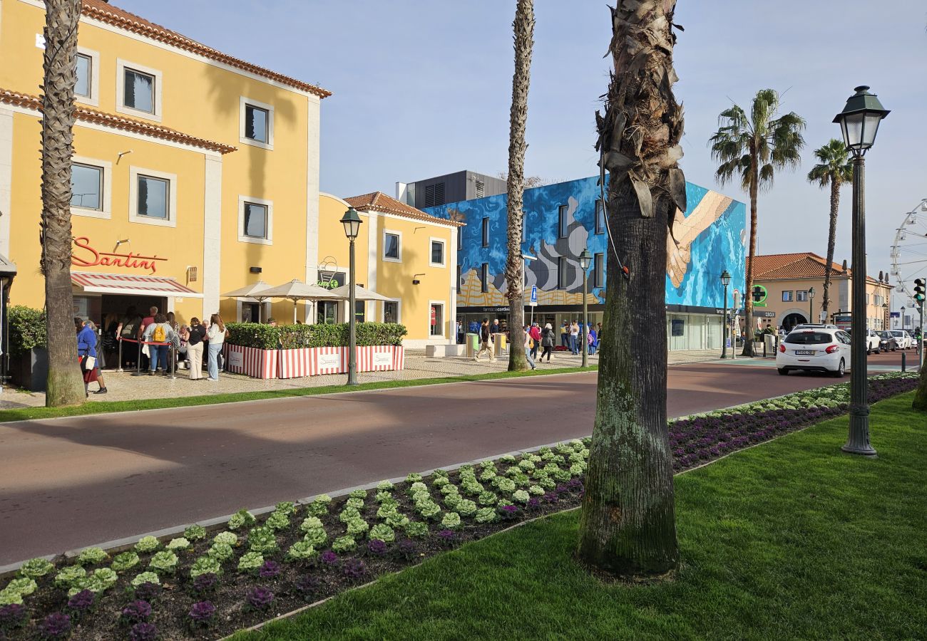Bustling avenue in Cascais' historic center, with shops, cafés, and traditional architecture.