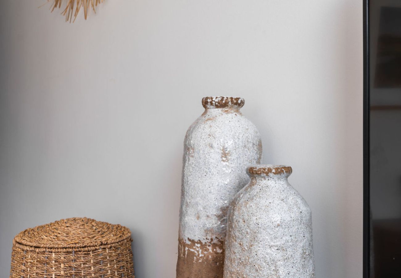 Detail of rustic-style decorative vases in the hallway at Pool Beach & Golf Troia.