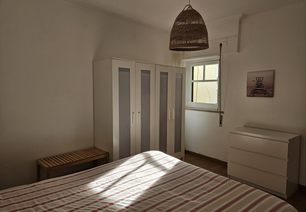 Bright bedroom with a double bed, large wardrobe, white dresser, and minimalist decor at Bolina 1 Historic Center Cascais.