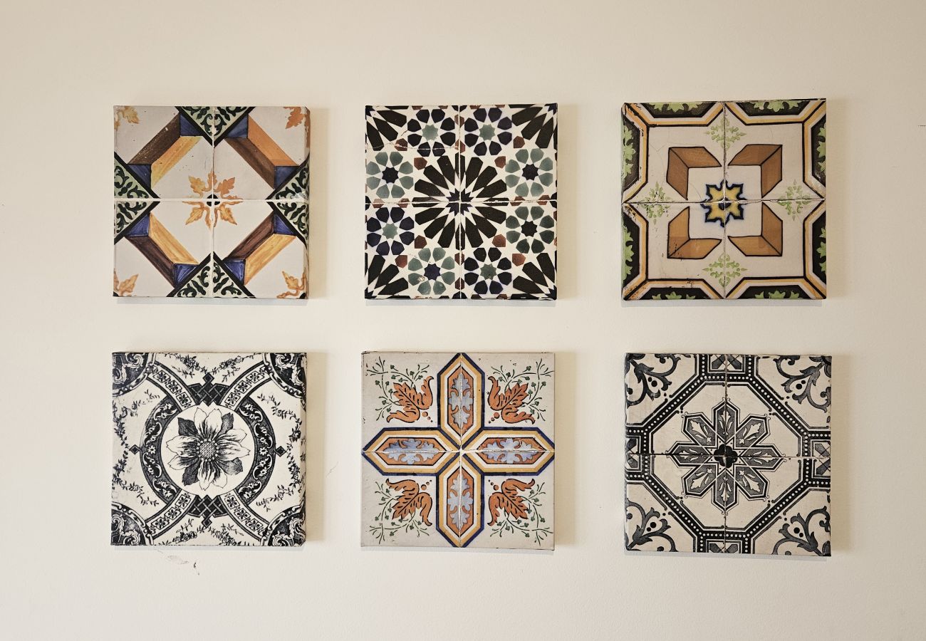 Decorative details on the living room wall, inspired by traditional Portuguese tiles.