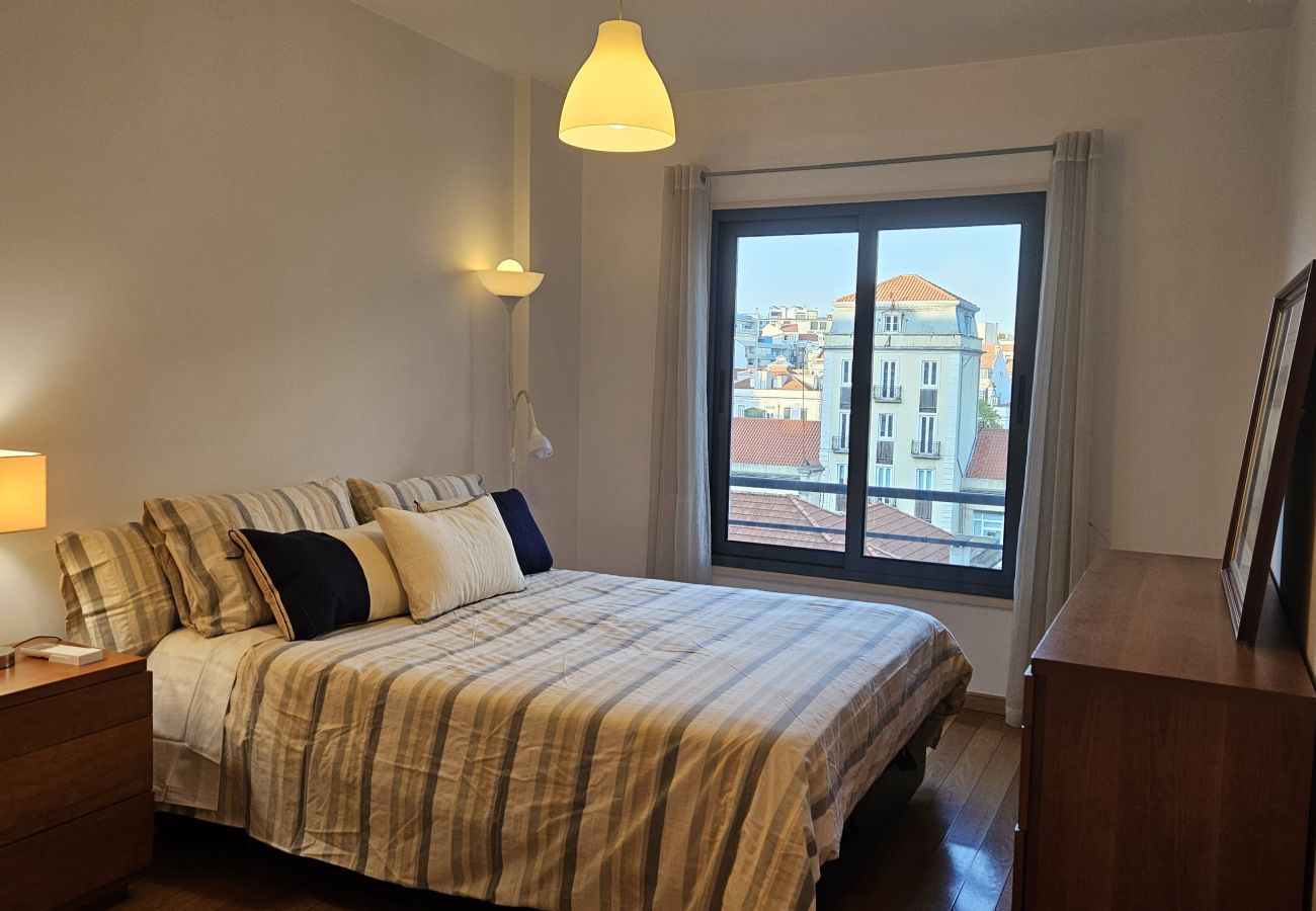  Large bed with an elegant headboard, contrasting pillows, and a sophisticated ambiance.
