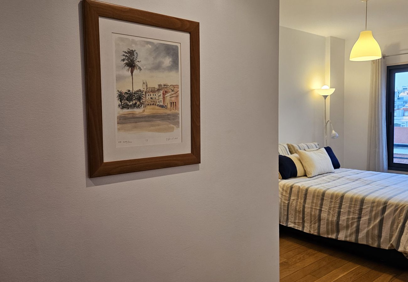  Bedroom with a king-size bed, minimalist decor, and large windows with natural light.