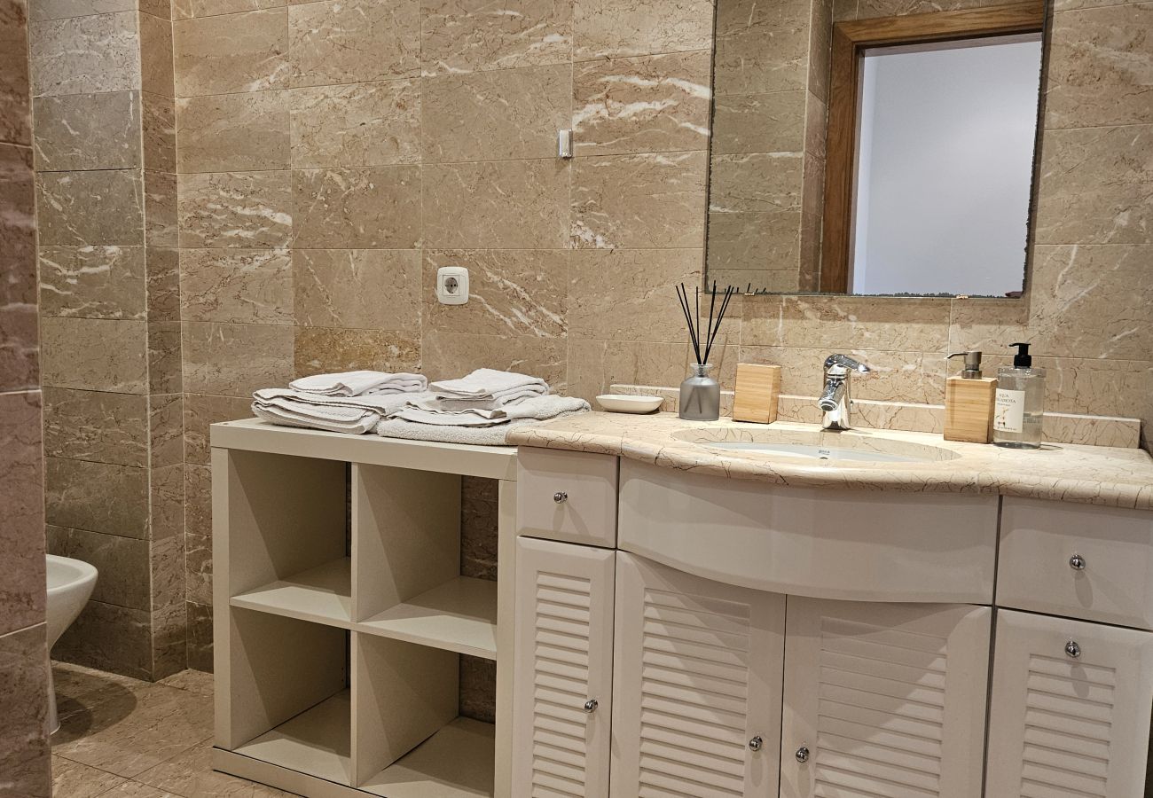 Bathroom with shower and bathtub, sophisticated design, and high-quality finishes.