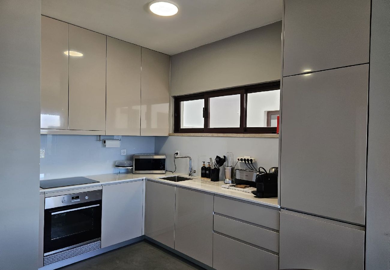 Sleek and functional kitchen with custom cabinets, built-in appliances, and a spacious countertop. 