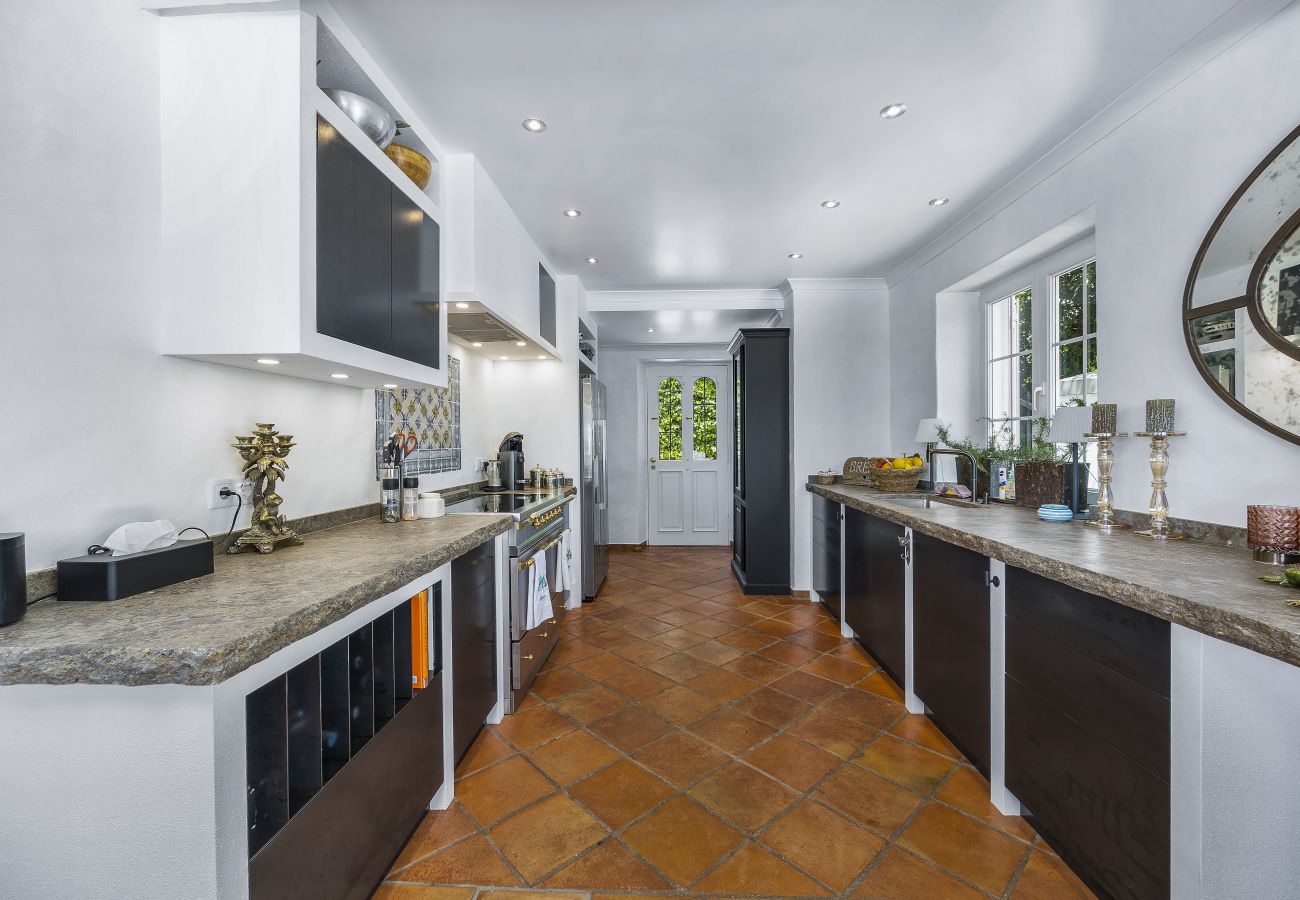 Spacious kitchen with stone countertops, sleek cabinets, and built-in lighting, providing a functional and elegant environment.