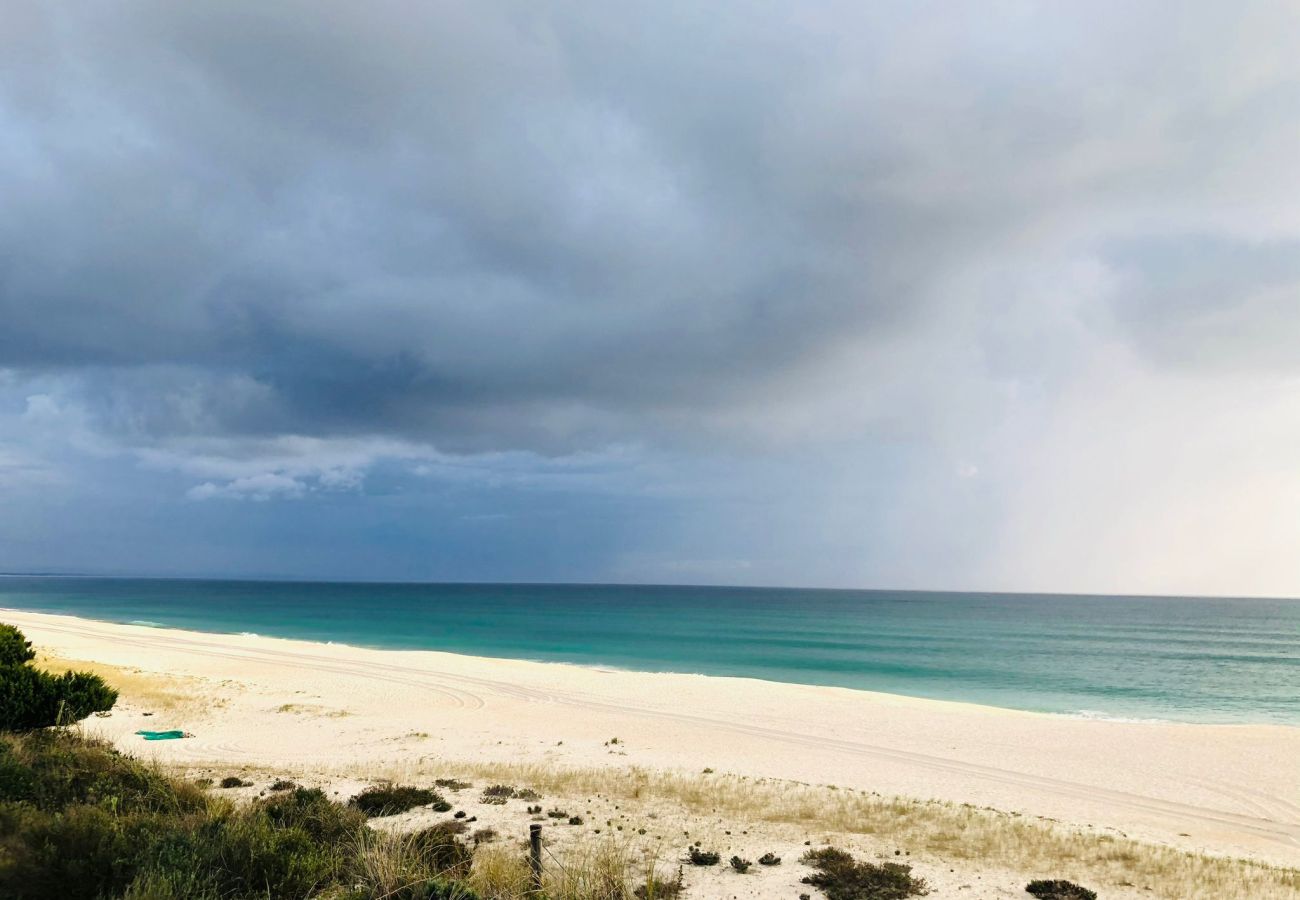  Panoramic view of Troia Sea with an infinite horizon and vibrant sky.