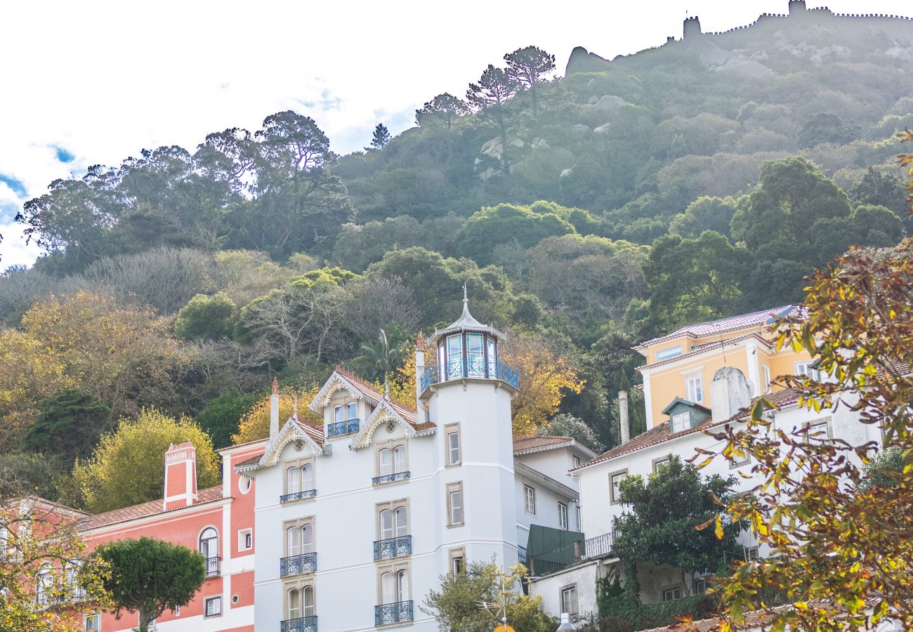 Charming buildings in Sintra, surrounded by lush greenery and rolling hills.