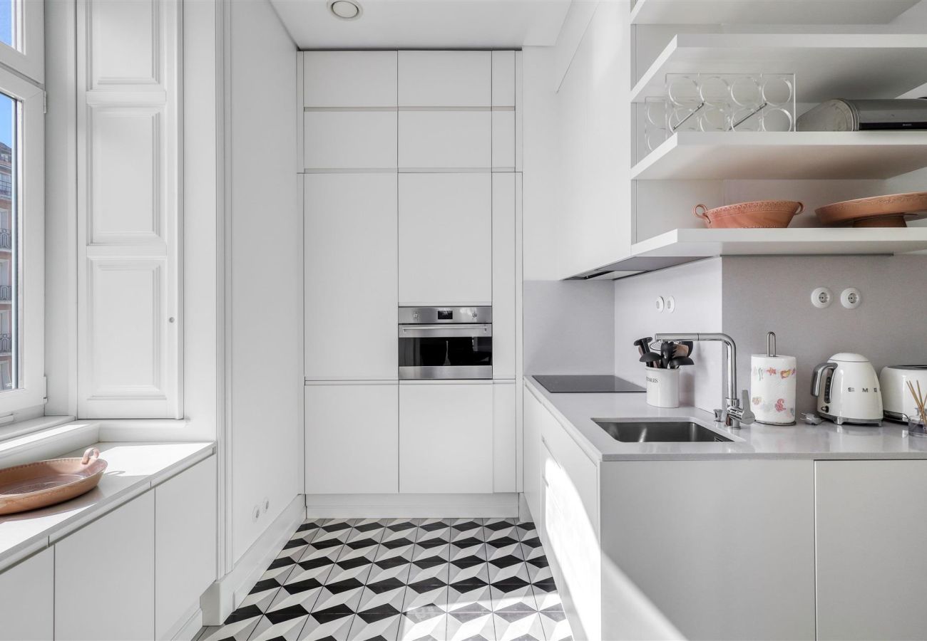  Bright and modern kitchen with built-in appliances, minimalist details, and an elegant geometric floor.